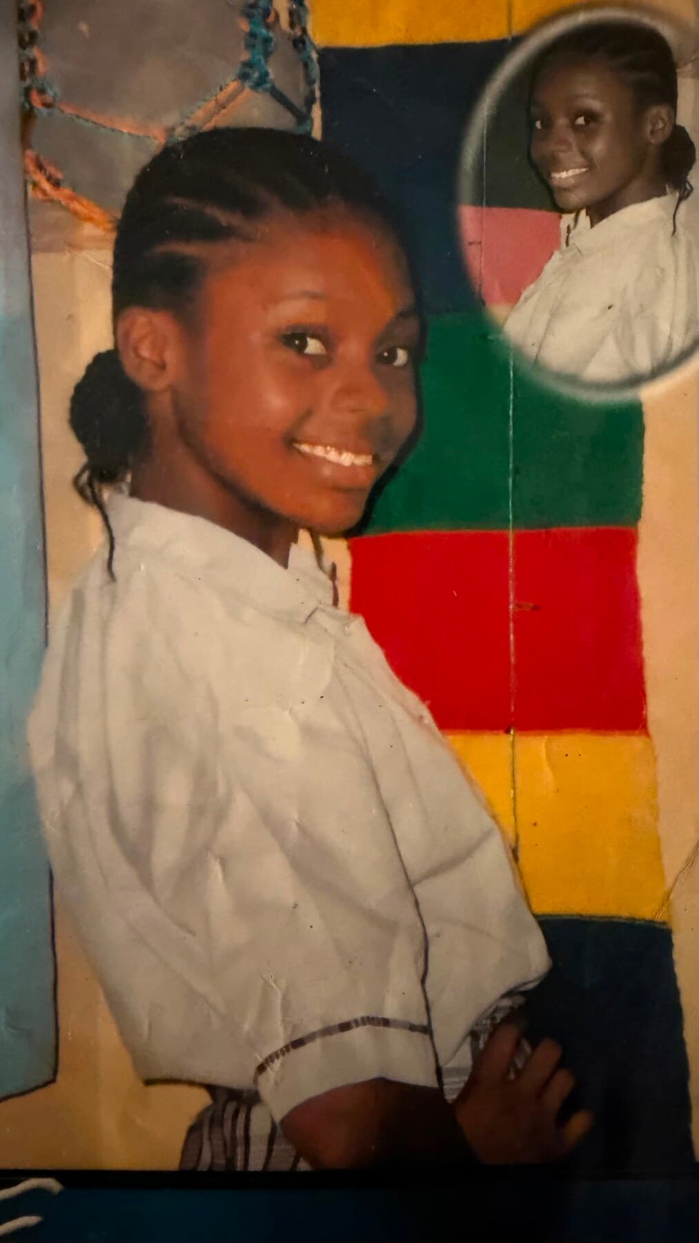 A childhood photo by a colorful mural