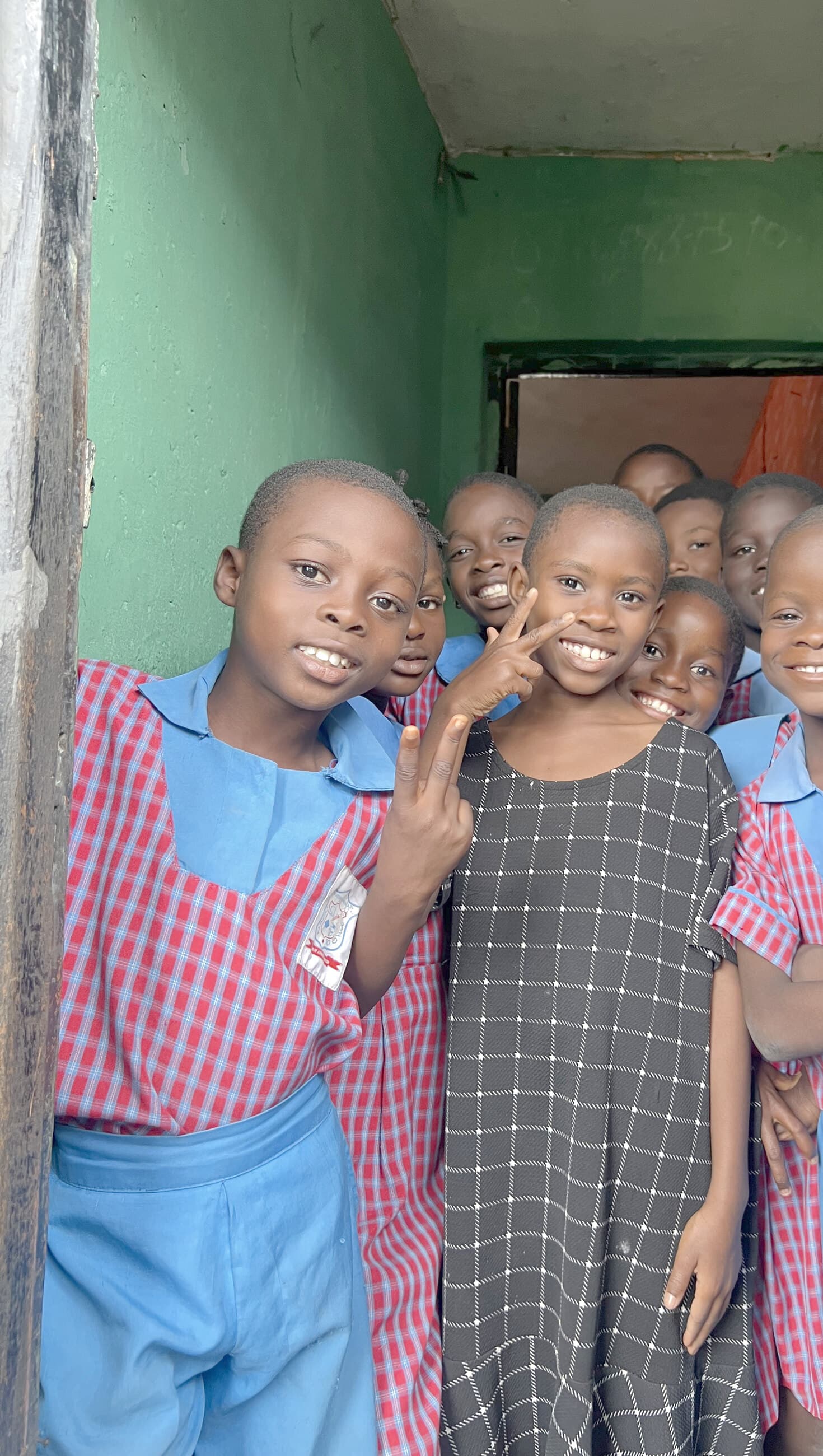 Schoolchildren at the doorway of the & I Foundation learning space